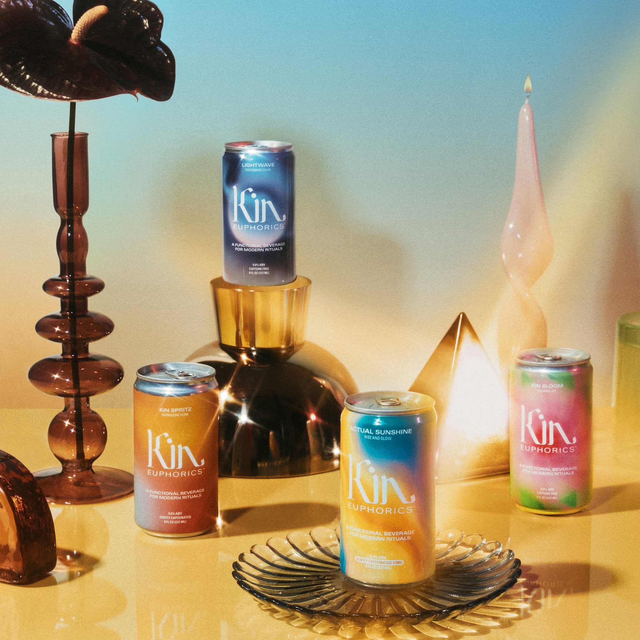 4 ready to drink can bundle including a 4 pack of kin bloom, 4 pack of kin spritz, 4 pack of lightwave, and a 4 pack of actual sunshine made from non-alcoholic beverage brand, kin euphorics.